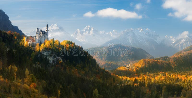 Germany. Panorama. The famous Neuschwanstein Castle and Hohenschwangau Castle on the background of snowy mountains.