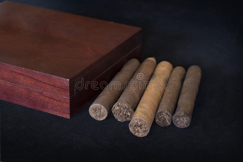 Group of rolled tobacco cigars with ash tray and cutters. Group of rolled tobacco cigars with ash tray and cutters