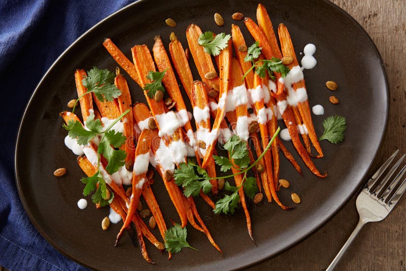 Roasted carrots with yogurt, cilantro and toasted pumpkin seeds. Roasted carrots with yogurt, cilantro and toasted pumpkin seeds