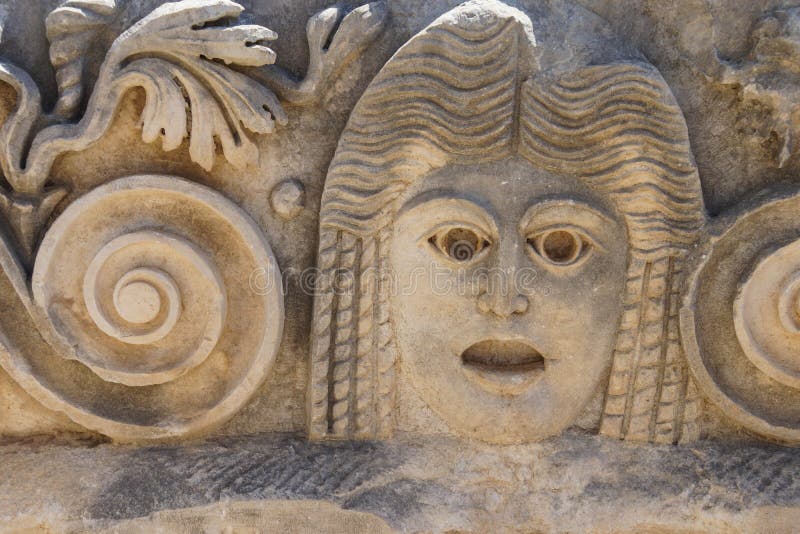 Carved Greek masks as decoration from the theatre of of Myra, Turkey. Carved Greek masks as decoration from the theatre of of Myra, Turkey
