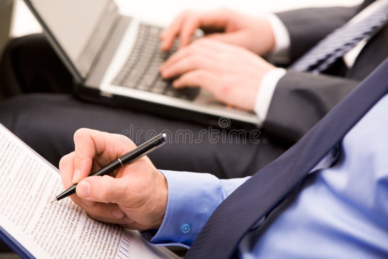 Close-up of ceo hand with pen making notes at briefing. Close-up of ceo hand with pen making notes at briefing