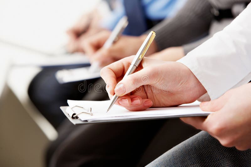 Close-up of human hands with pens over business documents. Close-up of human hands with pens over business documents