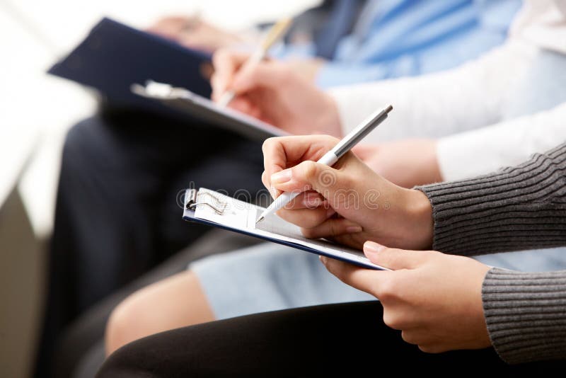 Close-up of human hands with pens over business documents. Close-up of human hands with pens over business documents