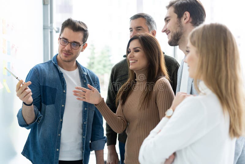 Business team with flip board in office discussing something. Business team with flip board in office discussing something