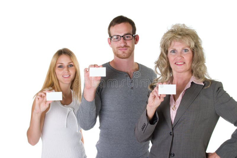 Three person business team with each holding a blank business card. Three person business team with each holding a blank business card.