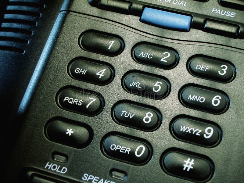 Close-up, macro shot of the number pad on a black business style telephone. Close-up, macro shot of the number pad on a black business style telephone