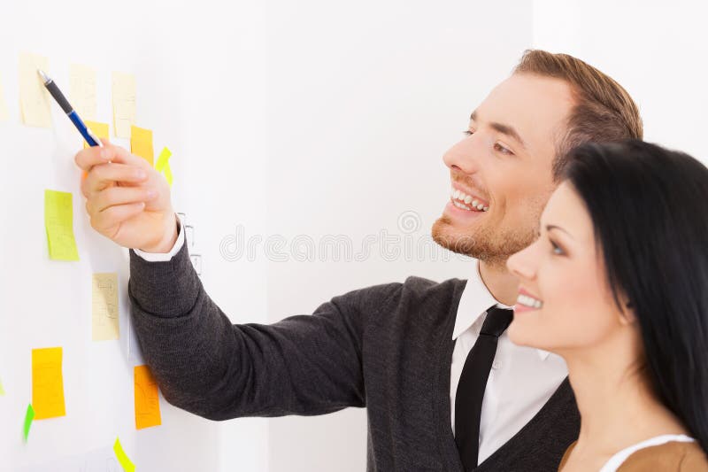 Business people making notes on adhesive paper. Business people making notes on adhesive paper