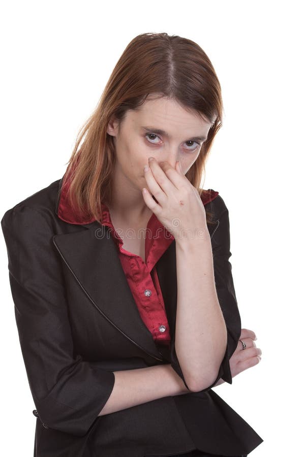 Woman dressed in business attire shown holding her nose as if she's offended by an odor. Woman dressed in business attire shown holding her nose as if she's offended by an odor.