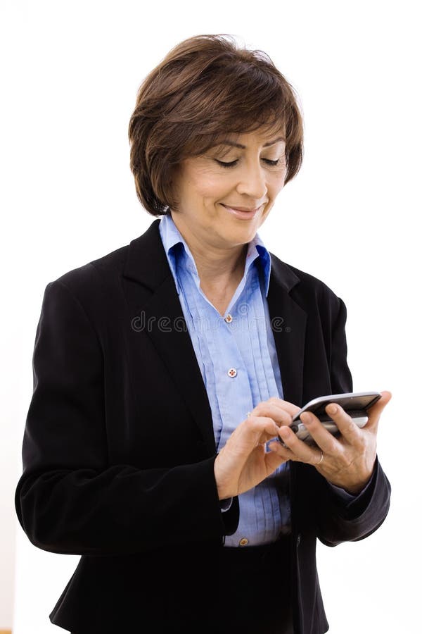 Senior businesswoman using mobile phone, writing email or text message. Isolated on white background. Senior businesswoman using mobile phone, writing email or text message. Isolated on white background.