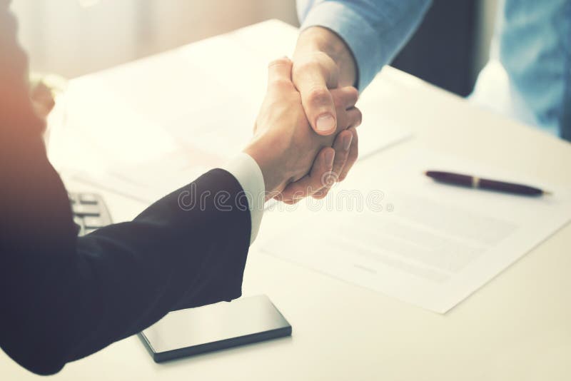 Business people handshake after partnership contract signing at office. Business people handshake after partnership contract signing at office