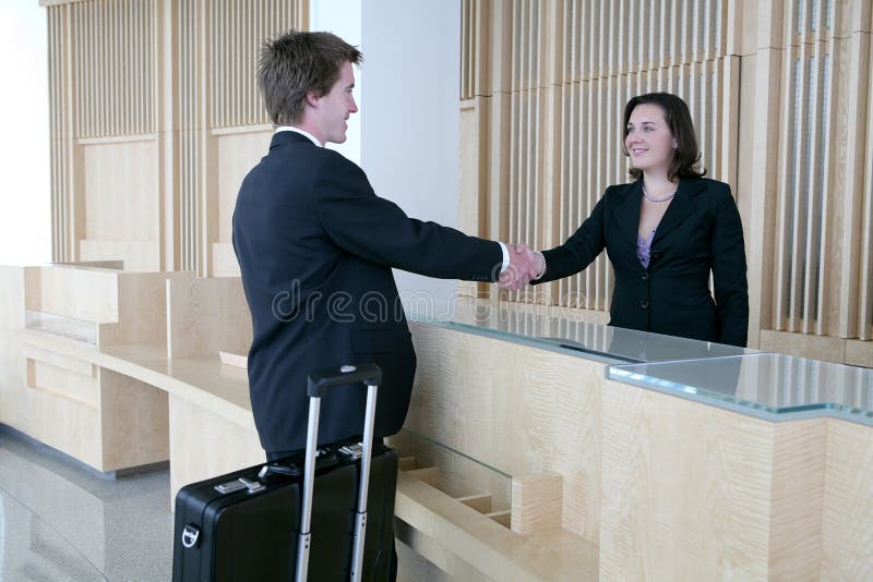 A business man arriving in the lobby for a sales meeting. A business man arriving in the lobby for a sales meeting