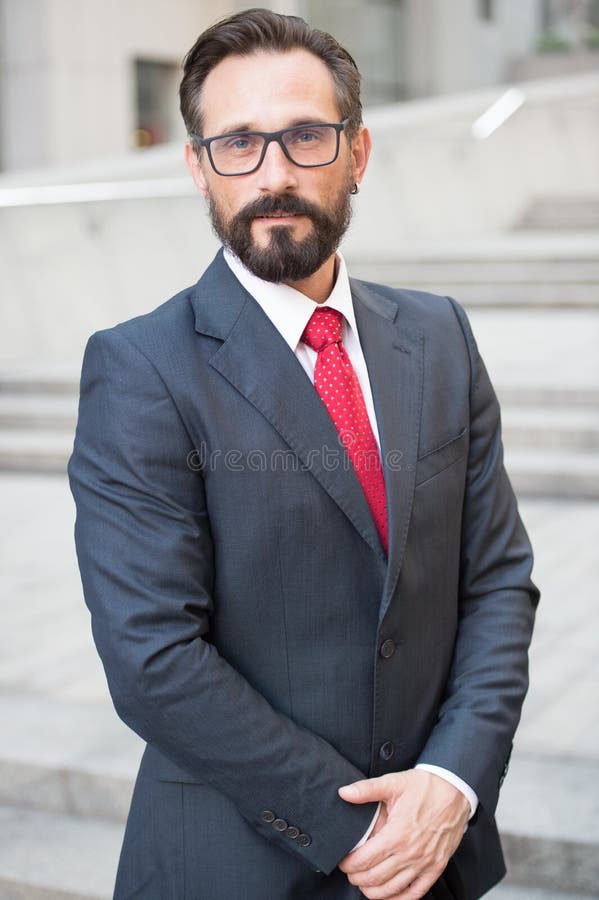 Businessman outdoor on business center background. Successful business person portrait. Professional people in formal wear with red tie. Businessman outdoor on business center background. Successful business person portrait. Professional people in formal wear with red tie