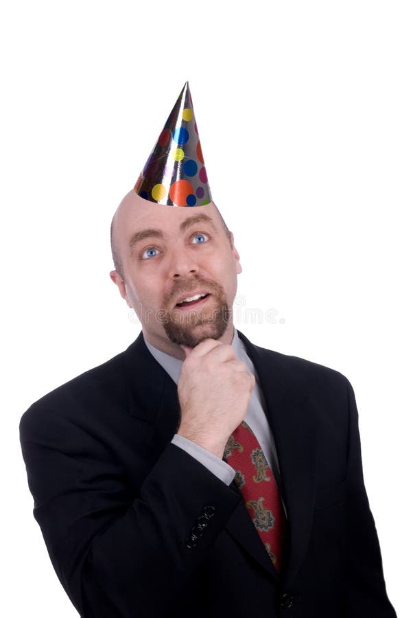 Businessman with a serious look wearing a party hat isolated over white with a clipping path. Businessman with a serious look wearing a party hat isolated over white with a clipping path