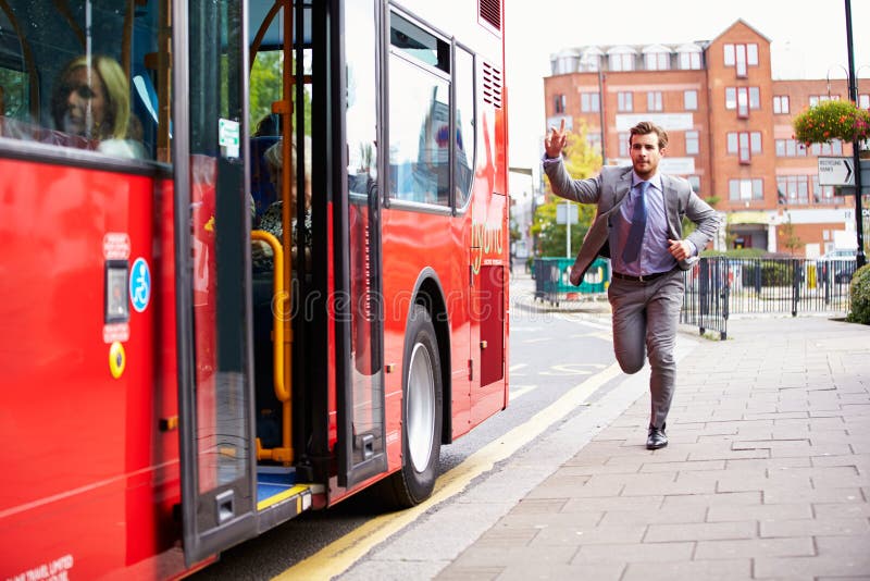 Businessman Running To Catch Bus Stop Raising His Arm. Businessman Running To Catch Bus Stop Raising His Arm