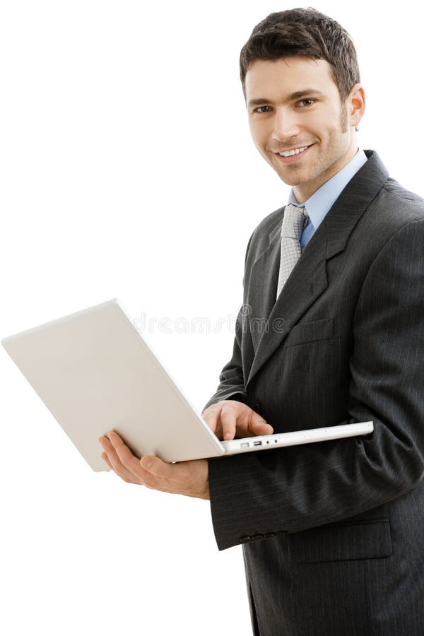 Businessman using laptop computer, standing, smiling. Isolated on white background. Businessman using laptop computer, standing, smiling. Isolated on white background.