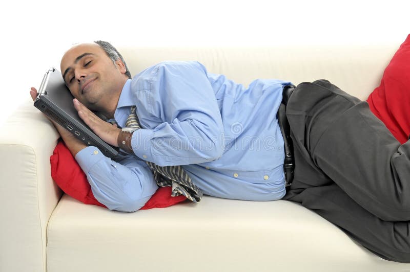 Businessman with laptop sleeping in a couch isolated in white. Businessman with laptop sleeping in a couch isolated in white