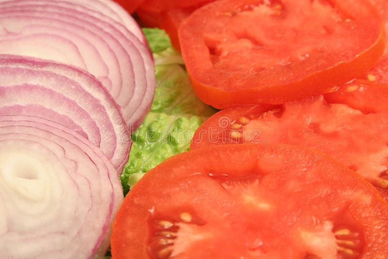 Sliced onion and tomato upclose. Sliced onion and tomato upclose