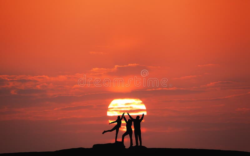 Sunset landscape with silhouette of a happy family with raised-up arms against the sun and colorful sky on the hill in summer. Travel background. Sunset landscape with silhouette of a happy family with raised-up arms against the sun and colorful sky on the hill in summer. Travel background