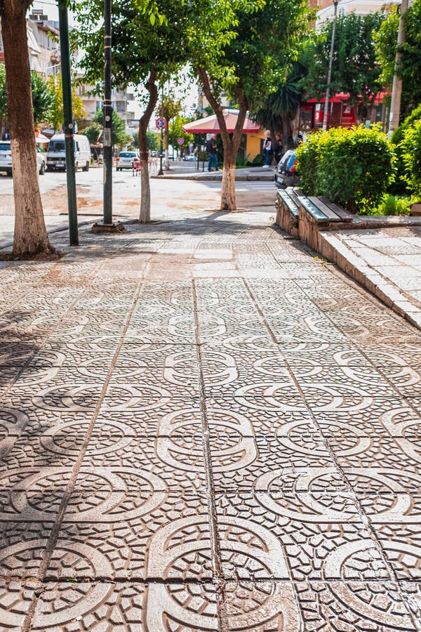 Stamped concrete pavement cobblestones pattern, decorative appearance colors and textures of paving cobblestones tile on cement flooring in a city park. Stamped concrete pavement cobblestones pattern, decorative appearance colors and textures of paving cobblestones tile on cement flooring in a city park