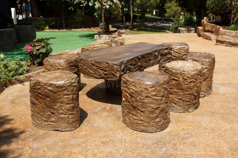 Table and stools made of stamped pattern concrete in an open air area. Exterior design decoration ideas. Table and stools made of stamped pattern concrete in an open air area. Exterior design decoration ideas