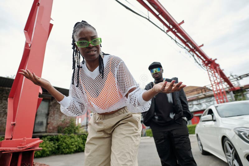 Gesting Woman with Sunglass and Man in Background stock images