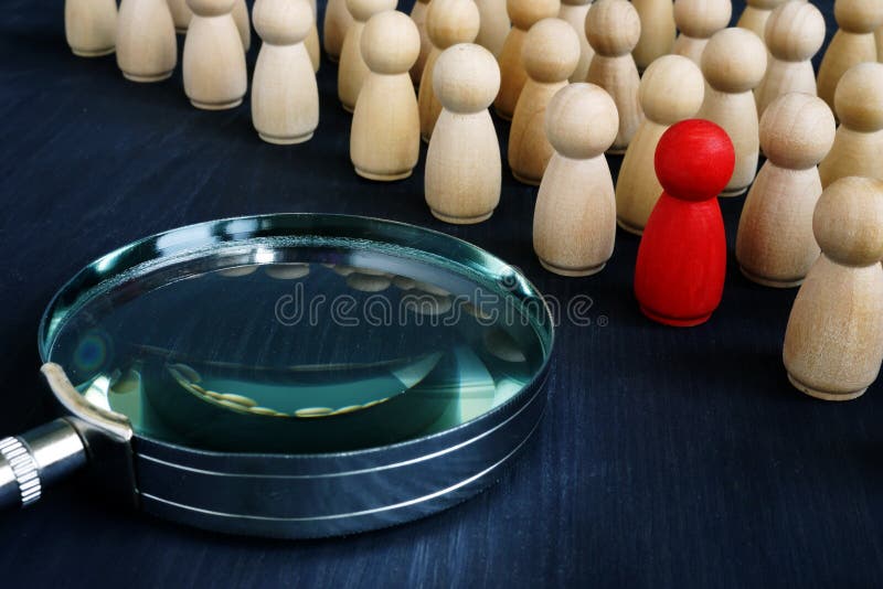 Talent management and recruitment concept. Magnifying glass and figurines. Talent management and recruitment concept. Magnifying glass and figurines