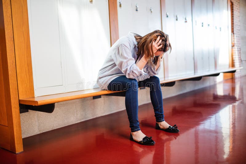 Gestraffte Frau, die im Umkleideraum sitzt stockfoto Gestraffte Frau, die im Umkleideraum sitzt stockfoto