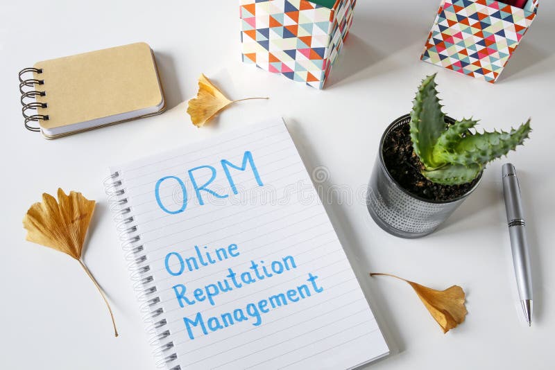 ORM Online Reputation Management written in notebook on white table. ORM Online Reputation Management written in notebook on white table