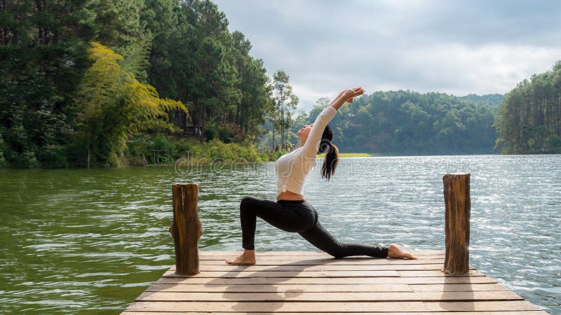 Healthy Yoga woman lifestyle balanced practicing meditate and energy yoga on the bridge in morning and sunset outdoors nature. Healthy life Concept. Healthy Yoga woman lifestyle balanced practicing meditate and energy yoga on the bridge in morning and sunset outdoors nature. Healthy life Concept