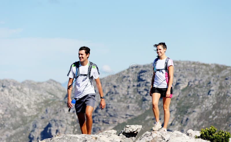 Young couple hiking outdoors in the sunshine, healthy lifestyle concept. Young couple hiking outdoors in the sunshine, healthy lifestyle concept