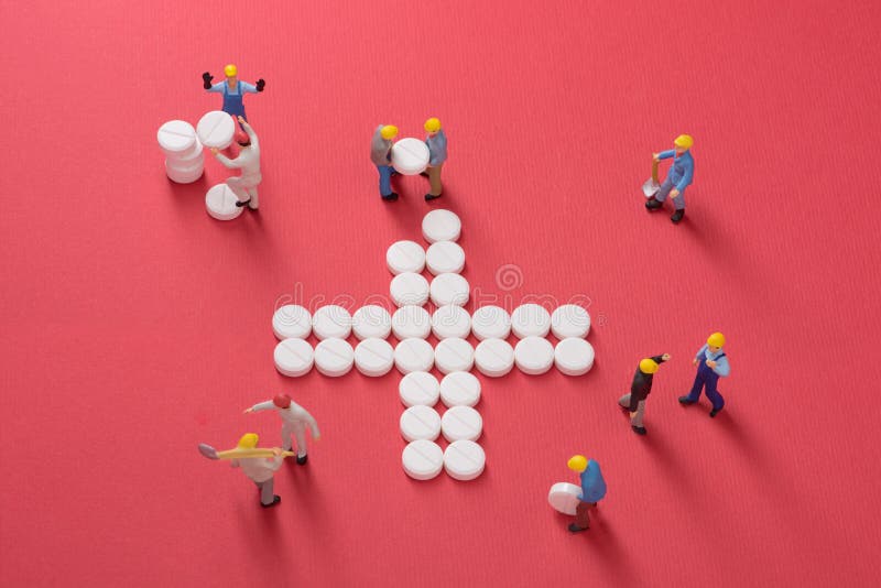 Healthcare system growth. Working men building a cross made of pills, symbol for medical services. Healthcare system growth. Working men building a cross made of pills, symbol for medical services