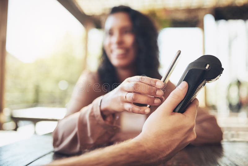 Get the app thatll make life so much simpler. a female customer making a wireless payment in a coffee shop. stock photos