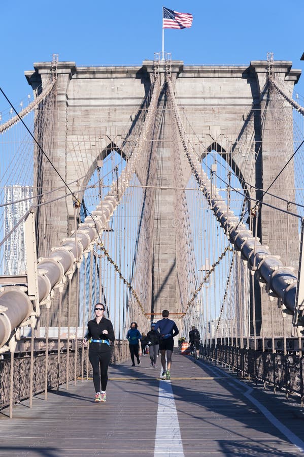 NEW YORK CITY - OCTOBER 26: The pedestrian walkway along The Brooklyn Bridge in New York City on October 26, 2013. Approximately 4,000 pedestrians and 3,100 cyclists cross this historic bridge each day. NEW YORK CITY - OCTOBER 26: The pedestrian walkway along The Brooklyn Bridge in New York City on October 26, 2013. Approximately 4,000 pedestrians and 3,100 cyclists cross this historic bridge each day.