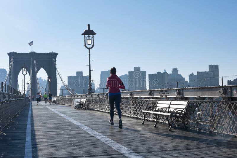 NEW YORK CITY - OCTOBER 26: The pedestrian walkway along The Brooklyn Bridge in New York City on October 26, 2013. Approximately 4,000 pedestrians and 3,100 cyclists cross this historic bridge each day. NEW YORK CITY - OCTOBER 26: The pedestrian walkway along The Brooklyn Bridge in New York City on October 26, 2013. Approximately 4,000 pedestrians and 3,100 cyclists cross this historic bridge each day.