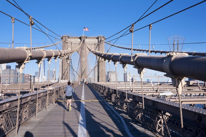 NEW YORK CITY - OCTOBER 26: The pedestrian walkway along The Brooklyn Bridge in New York City on October 26, 2013. Approximately 4,000 pedestrians and 3,100 cyclists cross this historic bridge each day. NEW YORK CITY - OCTOBER 26: The pedestrian walkway along The Brooklyn Bridge in New York City on October 26, 2013. Approximately 4,000 pedestrians and 3,100 cyclists cross this historic bridge each day.