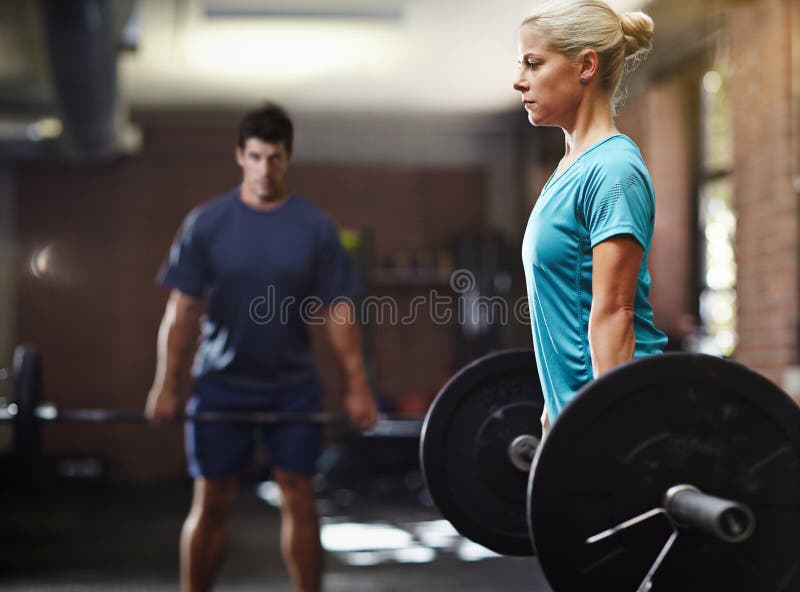 Get Focused, Get Fit. Two People Lifting Weights in a Gym. Stock Image Image of routine, focus