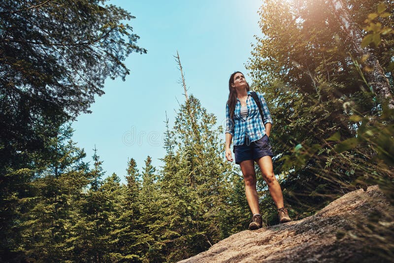 Get lost and find yourself. a young woman going for a hike through nature. stock photo