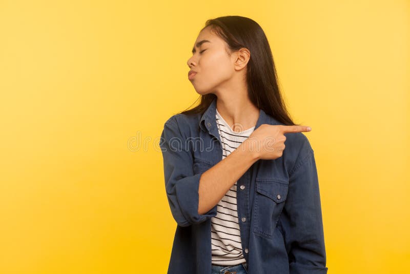 Get out, leave me! Portrait of annoyed vexed girl in denim shirt pointing way out and turning away