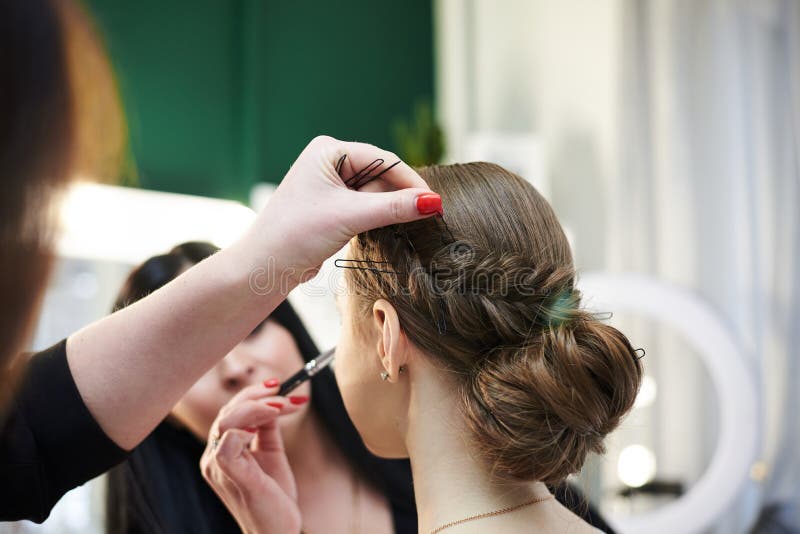 Getting Ready for Party. Young Pretty Girl Sitting in Beauty Salon while  Hairdresser and Make-up Artist Making Her Look Beautiful Stock Photo -  Image of hair, cosmetic: 215502824