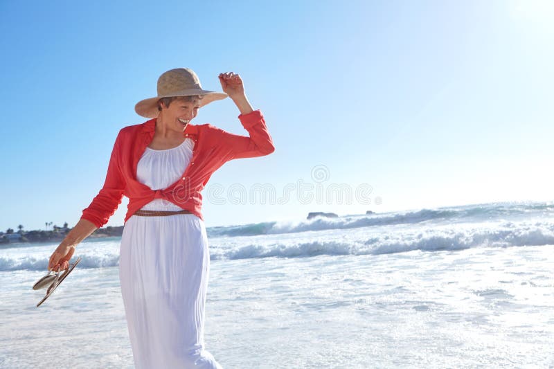 Getting Some Sun And Fresh Air An Attractive Mature Woman Enjoying A Day At The Beach Stock
