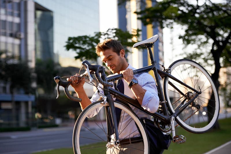 Getting to work with his trusty bike. a businessman commuting to work with his bicycle.