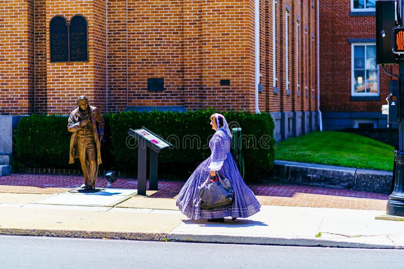 Gettysburg, PA, USA – July 3, 2022: A Civil War era reenactor walks on street in the historic town of Gettysburg wearing period over the July 4th celebration in Adams County, Pennsylvania. Gettysburg, PA, USA – July 3, 2022: A Civil War era reenactor walks on street in the historic town of Gettysburg wearing period over the July 4th celebration in Adams County, Pennsylvania