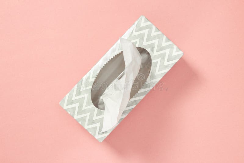 Gray tissue box on pastel pink background. Healthcare and hygiene. Gray tissue box on pastel pink background. Healthcare and hygiene.