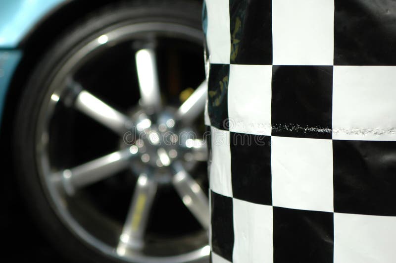 Sports car wheel and checkered barrel. Sports car wheel and checkered barrel