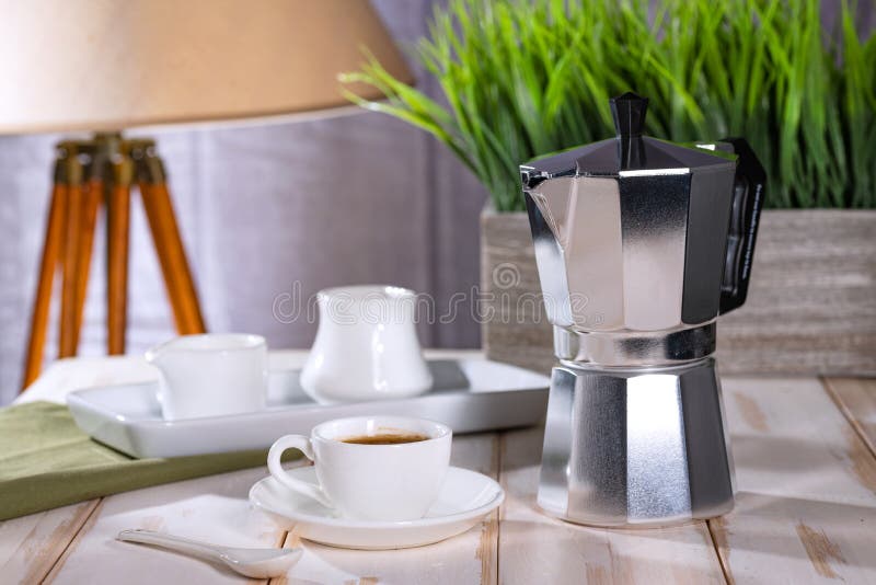 Geyser Coffee Maker and Freshly Brewed Coffee Stand on a White Kitchen