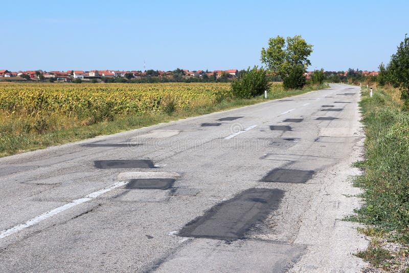 Poorly patched road in Negotin, Serbia. Regional road in Bor district of Serbia. Serbian countryside. Poorly patched road in Negotin, Serbia. Regional road in Bor district of Serbia. Serbian countryside.