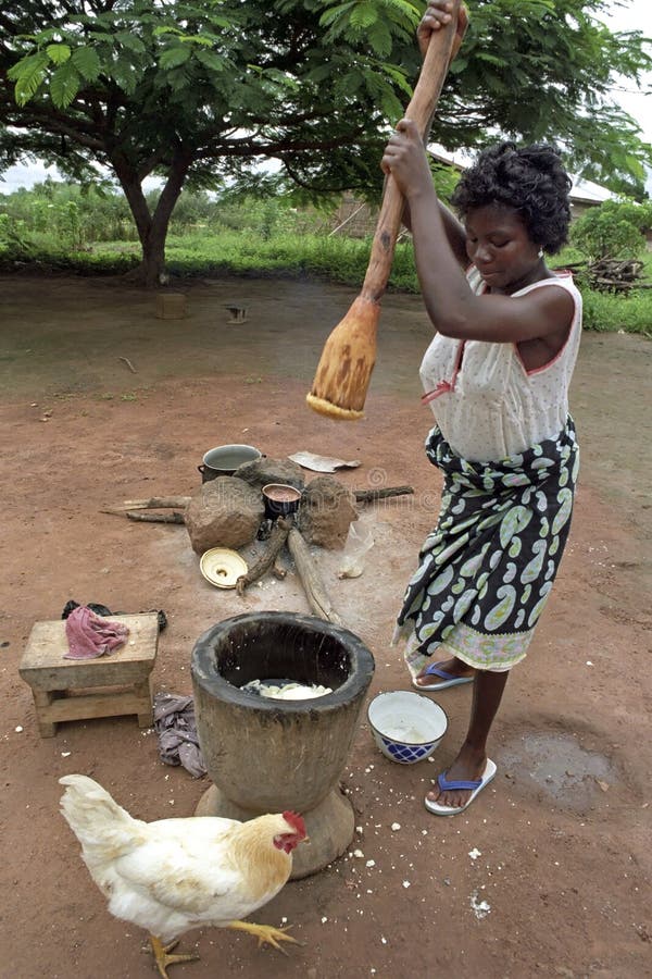 Ghanaian woman during cooking, mashing food