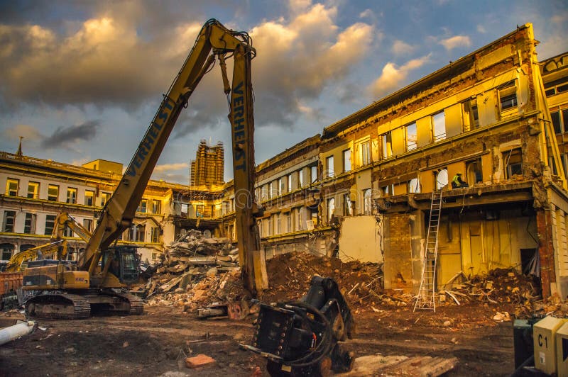 Ghent, Belgium. January 7, 2014. Demolition workers are busy tearing down an old building, while leaving the facade intact, in order to preserve the historic city atmosphere. Ghent, Belgium. January 7, 2014. Demolition workers are busy tearing down an old building, while leaving the facade intact, in order to preserve the historic city atmosphere.