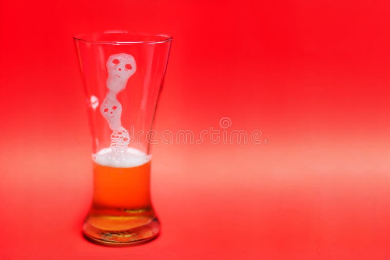 Ghost form of Beer bubbles in glass on red background