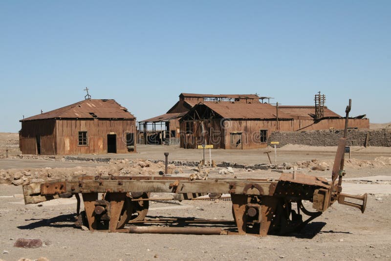 Ghost town in Atacama desert, Chile. Corroded ruins of 19th century nitrate factory Santa Laura with train wagon in the Atacama desert in Chile, declared UNESCO royalty free stock photos Ghost town in Atacama desert, Chile. Corroded ruins of 19th century nitrate factory Santa Laura with train wagon in the Atacama desert in Chile, declared UNESCO royalty free stock photos
